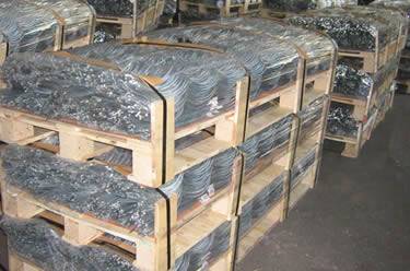 Many wooden pallets of galvanized tomato spiral stakes